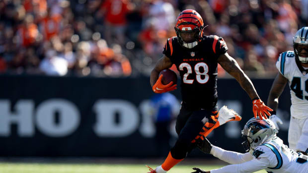 Cincinnati Bengals running back Joe Mixon (28) avoids a tackle by Carolina Panthers cornerback Myles Hartsfield (38) in the first quarter during a Week 9 NFL game, Sunday, Nov. 6, 2022, at Paycor Stadium in Cincinnati. Mandatory Credit: Albert Cesare-The Enquirer Nfl Carolina Panthers At Cincinnati Bengals